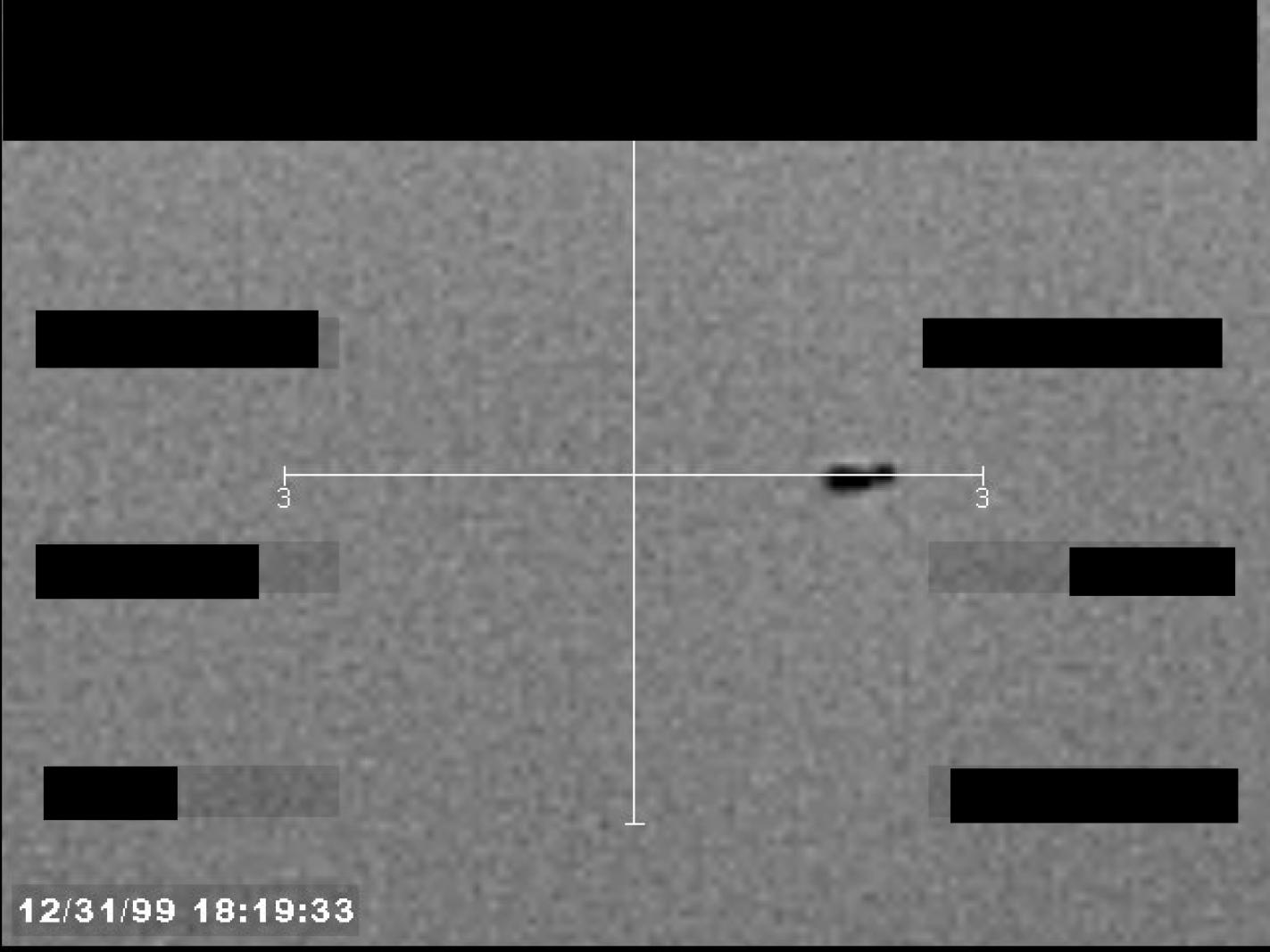 Derived page render from the official FBI Photo B23 PDF: redacted grayscale still frame with reticle, timestamp, and compact unresolved dark feature